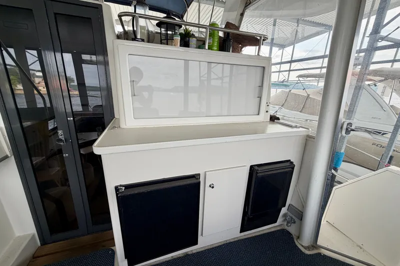 Slide: The Image of 1994 Carver 440 Aft Cabin Motor Yacht interior with storage and mini fridge. - 4