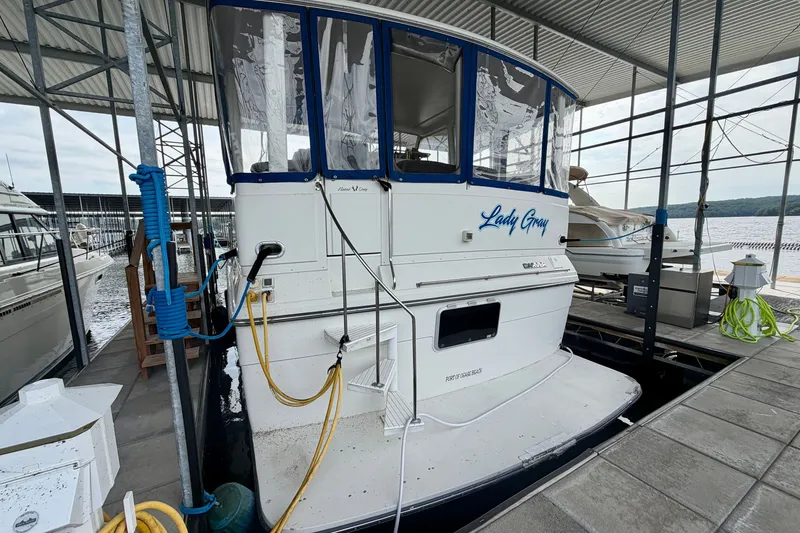 Slide: The Image of 1994 Carver 440 Aft Cabin Motor Yacht docked, featuring "Lady Gray" name on stern. - 1