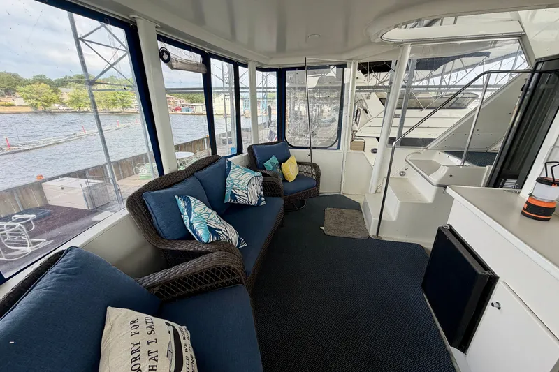 Slide: The Image of Cozy interior of 1994 Carver 440 Aft Cabin Motor Yacht with waterfront view. - 5