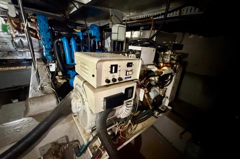 Slide: The Image of Engine room of a 1994 Carver 440 Aft Cabin Motor Yacht, featuring mechanical equipment. - 31