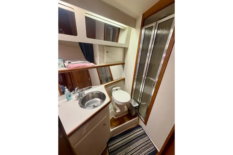 Slide: The Image of Bathroom interior of 1994 Carver 440 Aft Cabin Motor Yacht with sink, toilet, and shower. - 22