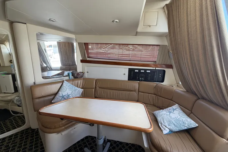 Slide: The Image of Interior of 2001 Carver 380 Santego SE yacht with cozy seating and dining area. - 14