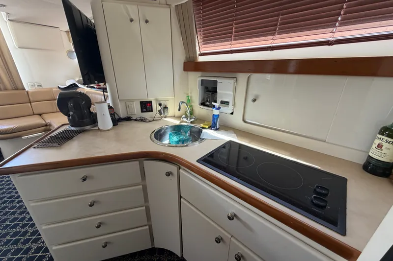 Slide: The Image of Interior of 2001 Carver 380 Santego SE yacht kitchen with sink and stove. - 18