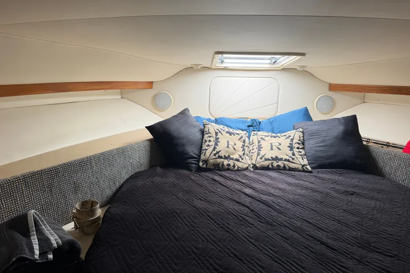 Slide: The Image of Cozy cabin interior of 2001 Carver 380 Santego SE with plush bedding and decorative pillows. - 8