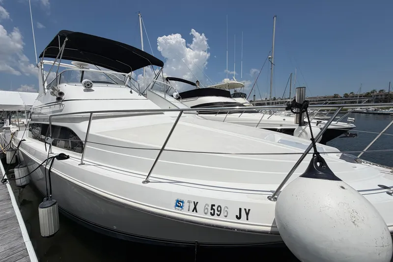 Slide: The Image of 2001 Carver 380 Santego SE yacht docked at marina under clear sky. - 5