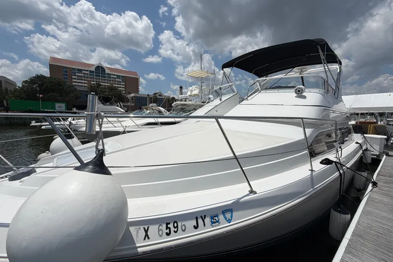 Slide: The Image of 2001 Carver 380 Santego SE yacht docked under cloudy sky. - 6