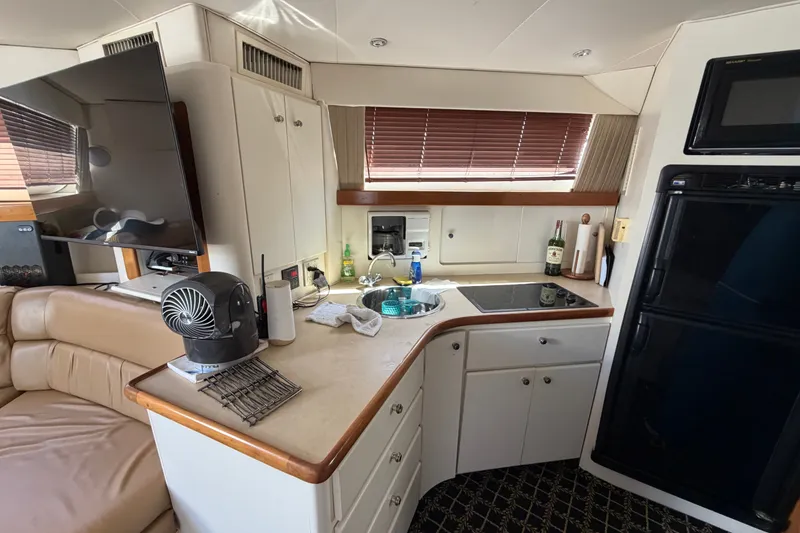 Slide: The Image of Interior of 2001 Carver 380 Santego SE yacht with kitchen and seating area. - 16