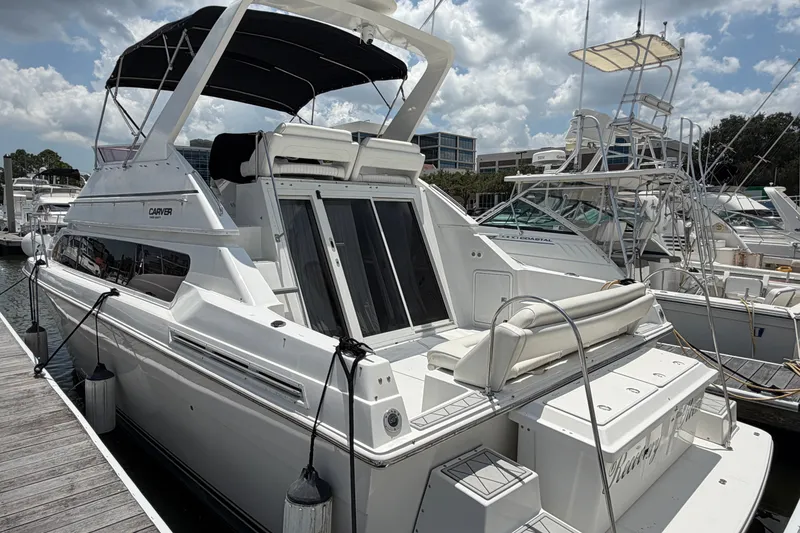 Slide: The Image of 2001 Carver 380 Santego SE yacht docked at marina under cloudy sky. - 4