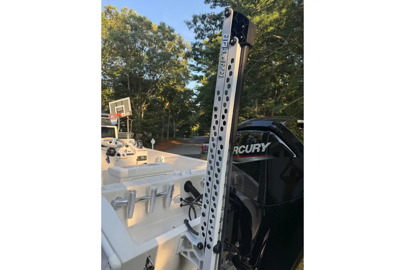 Slide: The Image of 2024 BlueCat 17 boat with Mercury engine and Raptor anchor system in a wooded setting. - 8
