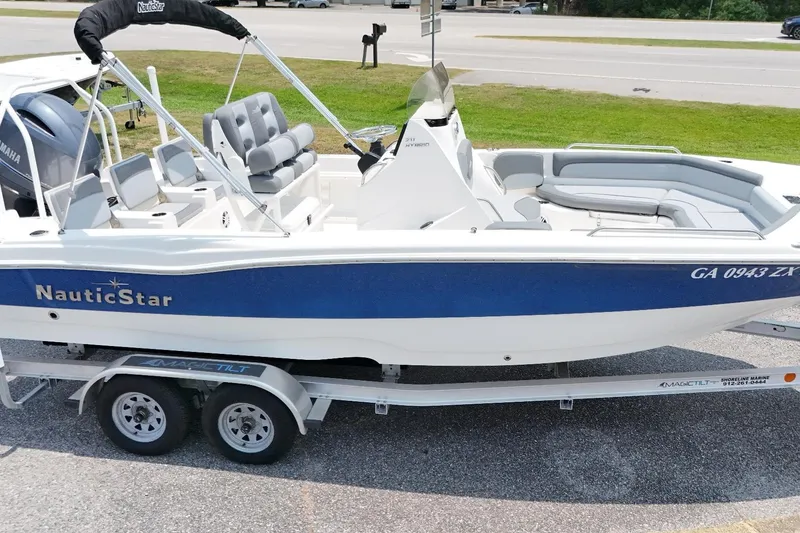 The Image of 2023 NauticStar 211 Hybrid boat on trailer, featuring sleek design and comfortable seating. - 1