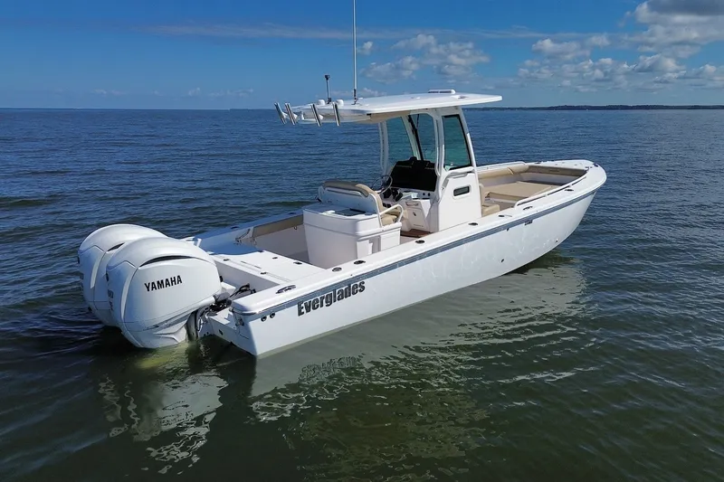 Slide: The Image of 2022 Everglades 273 Center Console boat with Yamaha engines on calm water. - 2