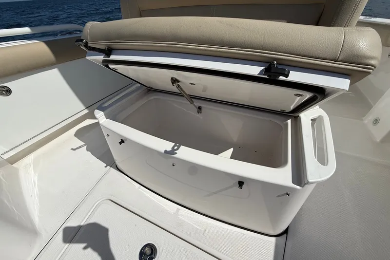 Slide: The Image of Open storage compartment on 2022 Everglades 273 Center Console boat, ocean in background. - 28
