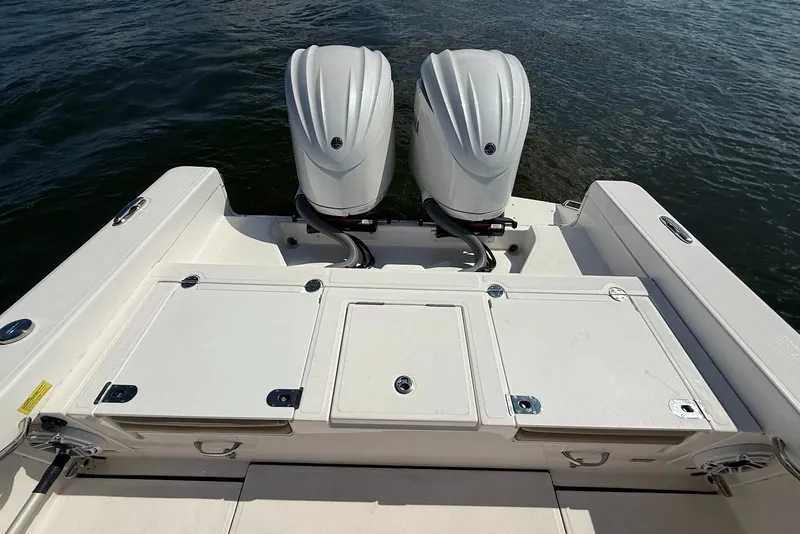 Slide: The Image of 2022 Everglades 273 Center Console boat with dual outboard engines on water. - 9