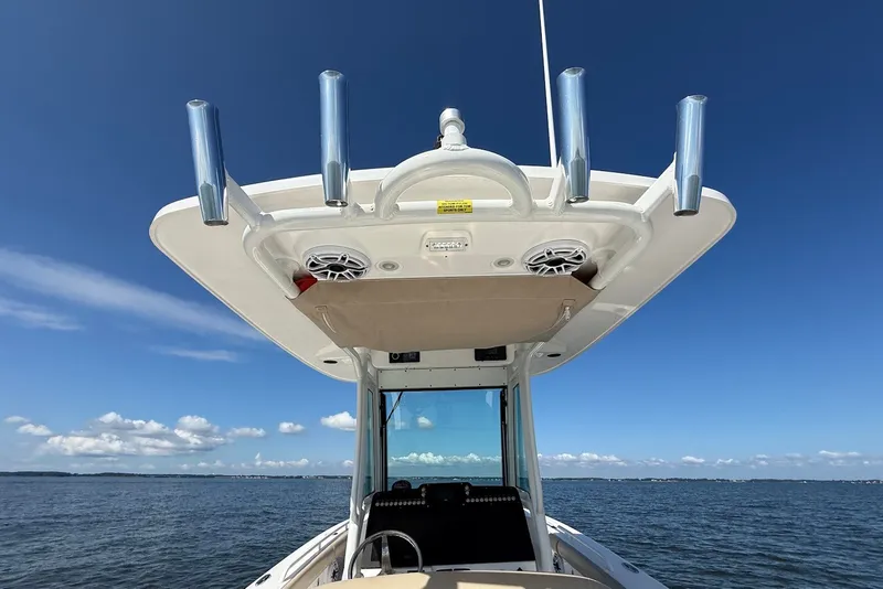 Slide: The Image of 2022 Everglades 273 Center Console boat on open water under clear blue sky. - 15