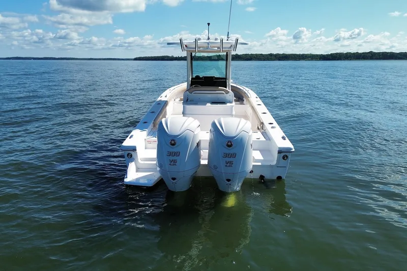 Slide: The Image of 2022 Everglades 273 Center Console boat with twin engines on calm water. - 3