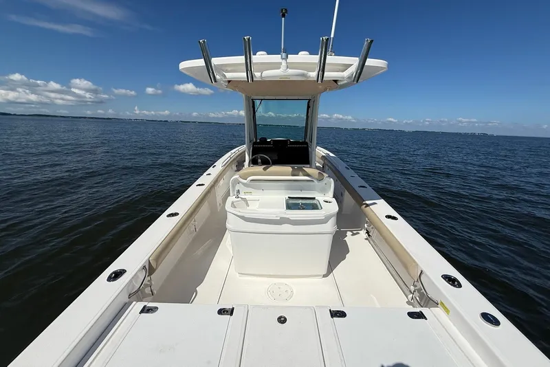 Slide: The Image of 2022 Everglades 273 Center Console boat on open water under clear blue sky. - 13