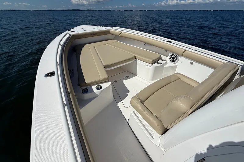Slide: The Image of 2022 Everglades 273 Center Console boat with beige seating on open water. - 26