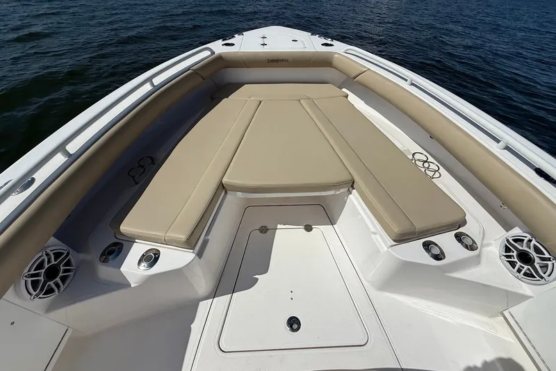 Slide: The Image of 2022 Everglades 273 Center Console boat with beige seating, on calm water. - 29