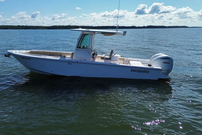 Slide: The Image of 2022 Everglades 273 Center Console boat on calm water under a clear sky. - 5
