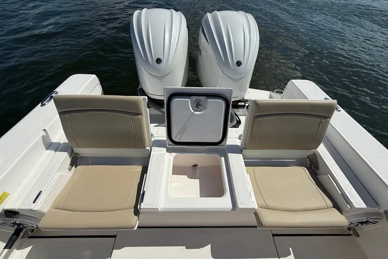 Slide: The Image of 2022 Everglades 273 Center Console boat with dual engines and seating, on water. - 10