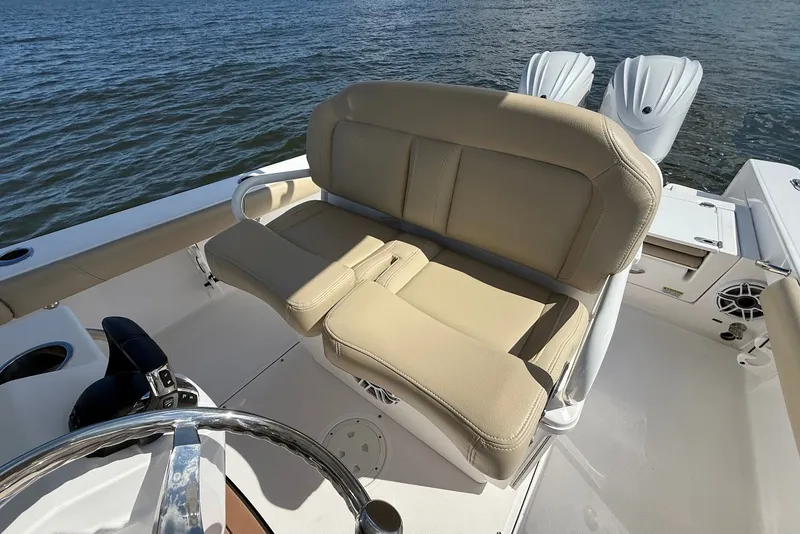 Slide: The Image of 2022 Everglades 273 Center Console boat with beige seating and dual outboard motors. - 18
