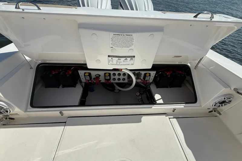 Slide: The Image of Open battery compartment of 2022 Everglades 273 Center Console boat, showing electrical components. - 11