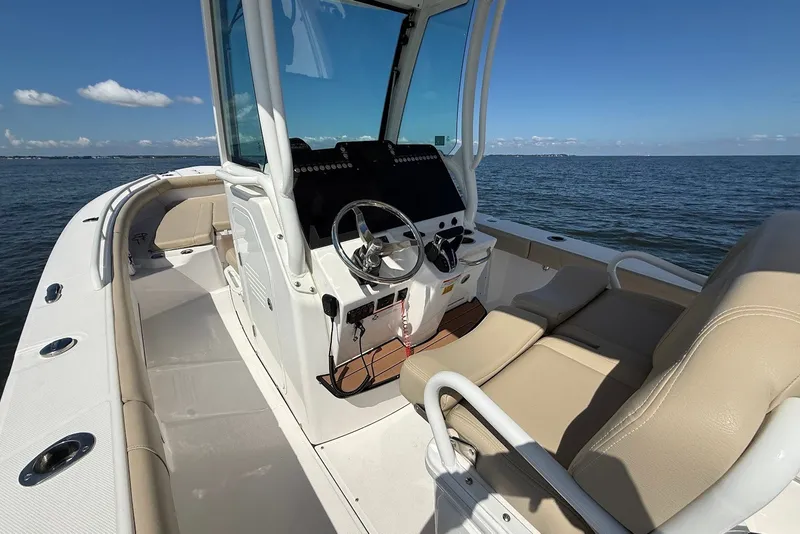 Slide: The Image of 2022 Everglades 273 Center Console boat on open water, featuring sleek design and spacious seating. - 17