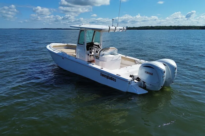 Slide: The Image of 2022 Everglades 273 Center Console boat on calm water with twin Yamaha engines. - 4