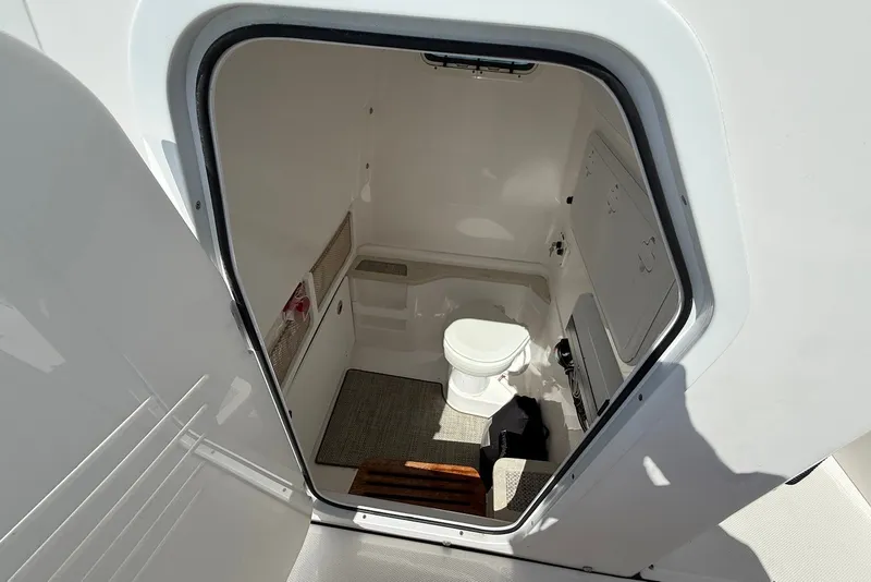 Slide: The Image of Interior view of 2022 Everglades 273 Center Console boat's compact bathroom. - 24