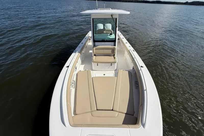 Slide: The Image of 2022 Everglades 273 Center Console boat on calm water, featuring spacious seating and sleek design. - 33