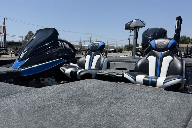 Slide: The Image of 2027 Skeeter FXE20 Limited boat interior with sleek black and blue seating. - 14