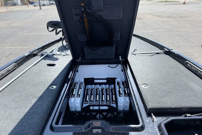 Slide: The Image of 2027 Skeeter FXE20 Limited boat with open storage compartment showcasing organized battery setup. - 21
