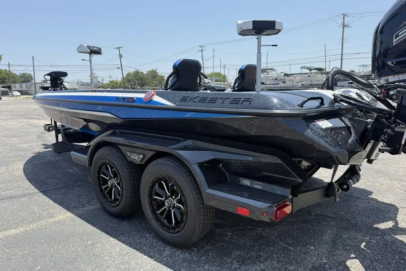 Slide: The Image of 2027 Skeeter FXE20 Limited boat on trailer, sleek design, dual axles, outdoor setting. - 18