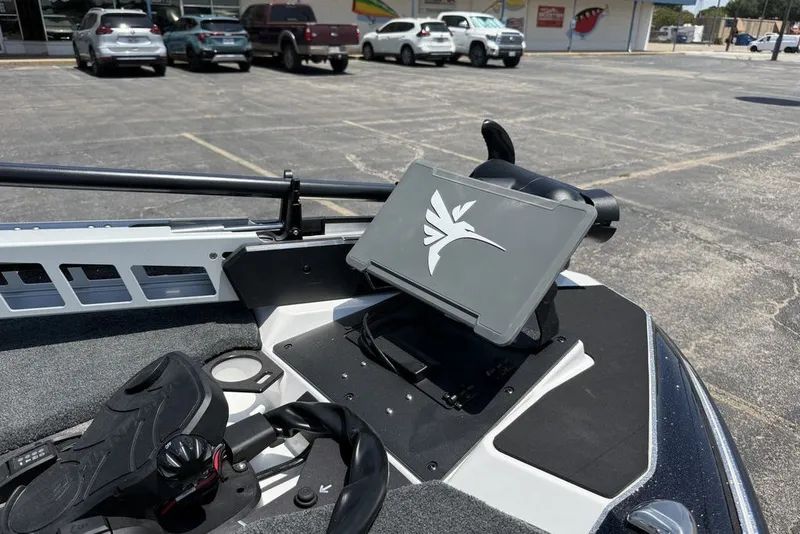 Slide: The Image of 2027 Skeeter FXE20 Limited boat dashboard with mounted electronic device in parking lot. - 17