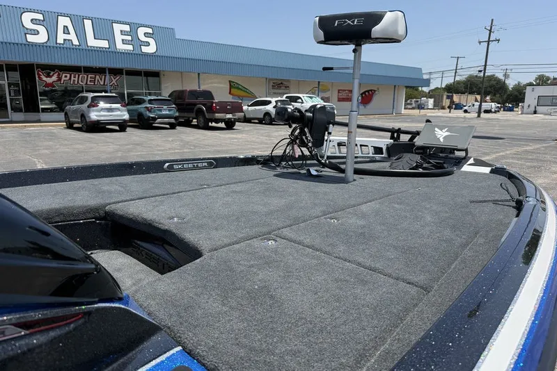 Slide: The Image of 2027 Skeeter FXE20 Limited boat displayed outside a sales showroom. - 20