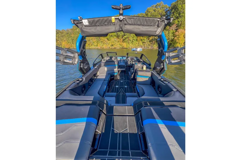 Slide: The Image of 2024 Supra SV 400 boat interior with sleek seating and advanced features on a sunny lake. - 14