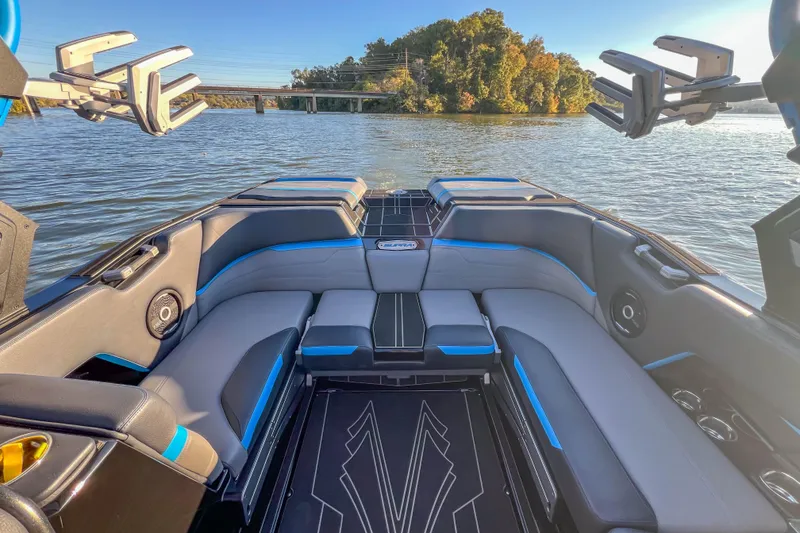 Slide: The Image of 2024 Supra SV 400 boat interior with sleek seating and water view. - 18