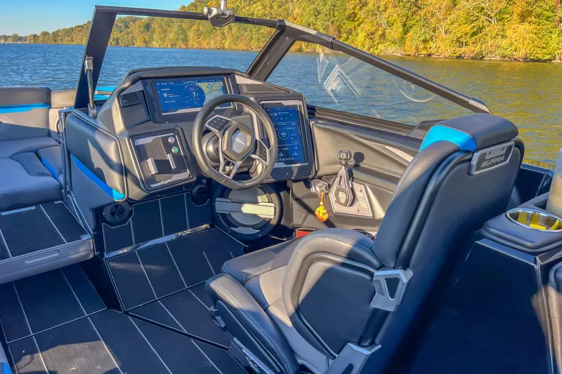 Slide: The Image of 2024 Supra SV 400 boat interior with modern dashboard and steering on a lake. - 20