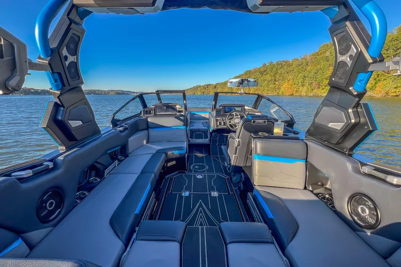 Slide: The Image of 2024 Supra SV 400 boat interior with sleek design on a scenic lake. - 23