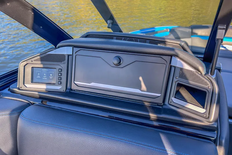 Slide: The Image of 2024 Supra SV 400 boat dashboard with control panel and speakers, overlooking water. - 31