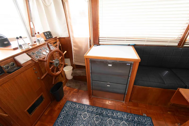 Slide: The Image of Interior of a 1974 Grand Banks 42 Classic boat with wooden helm and seating area. - 19