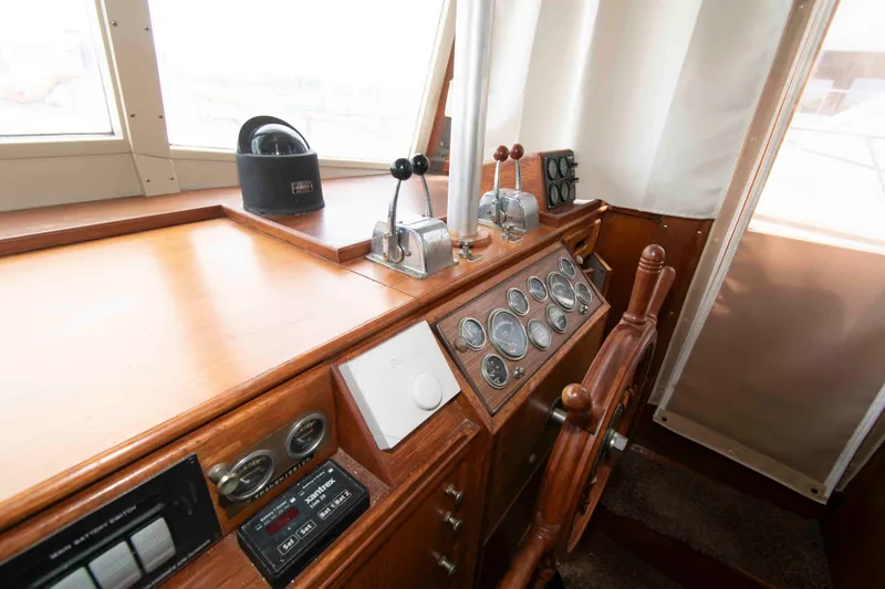 Slide: The Image of Helm of 1974 Grand Banks 42 Classic yacht with wooden wheel and navigation instruments. - 22
