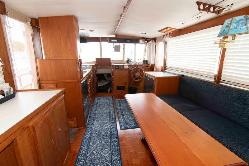 Slide: The Image of Interior of a 1974 Grand Banks 42 Classic yacht with wood paneling and nautical decor. - 15