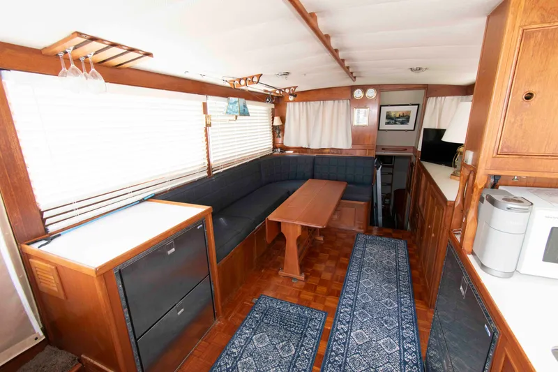 Slide: The Image of Interior of a 1974 Grand Banks 42 Classic yacht with wood paneling and cozy seating area. - 17