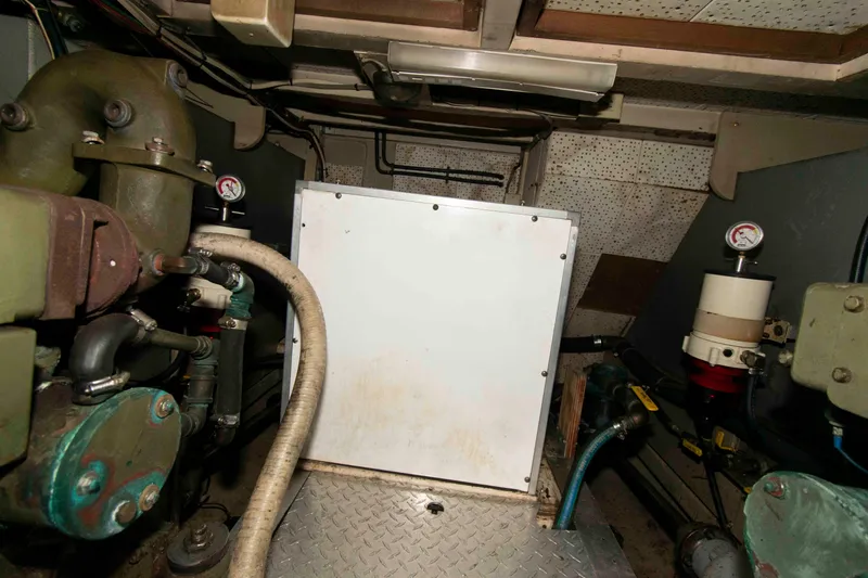 Slide: The Image of Engine room of a 1974 Grand Banks 42 Classic boat, featuring mechanical components. - 31