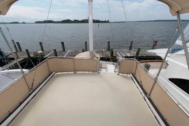 Slide: The Image of 1974 Grand Banks 42 Classic yacht deck with scenic waterfront view. - 7