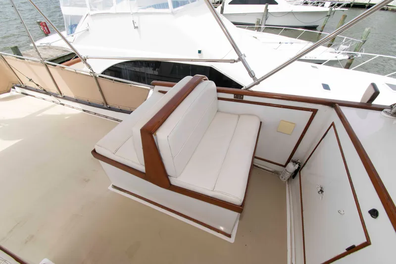 Slide: The Image of 1974 Grand Banks 42 Classic yacht with white seating and wooden trim on deck. - 10