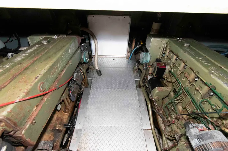 Slide: The Image of Engine room of a 1974 Grand Banks 42 Classic boat, featuring twin diesel engines. - 29