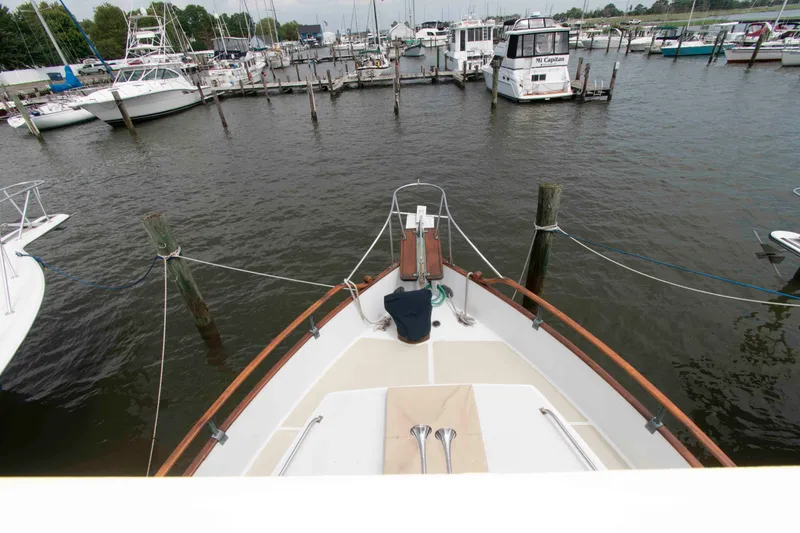 Slide: The Image of Bow view of 1974 Grand Banks 42 Classic yacht docked at marina. - 13
