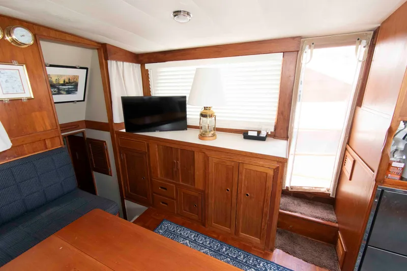 Slide: The Image of Interior of a 1974 Grand Banks 42 Classic yacht with wood cabinetry and a TV. - 20